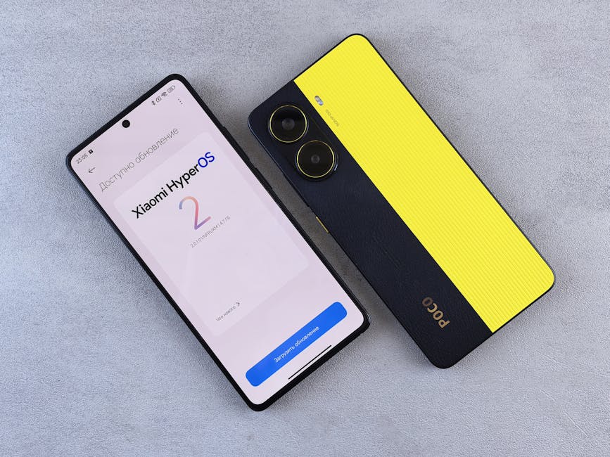 Top view of two smartphones displaying Xiaomi HyperOS update screen and POCO branding on a plain surface