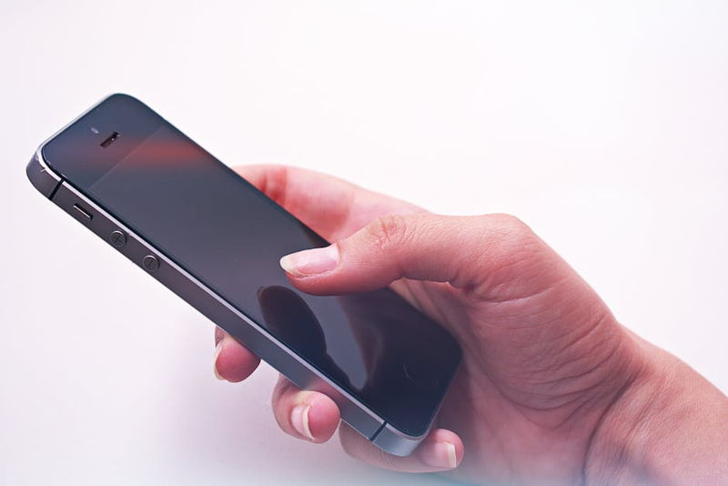 A persons hand holding a smartphone showcasing modern technology and connectivity